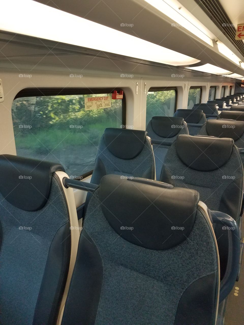 An empty car of a commuter train.