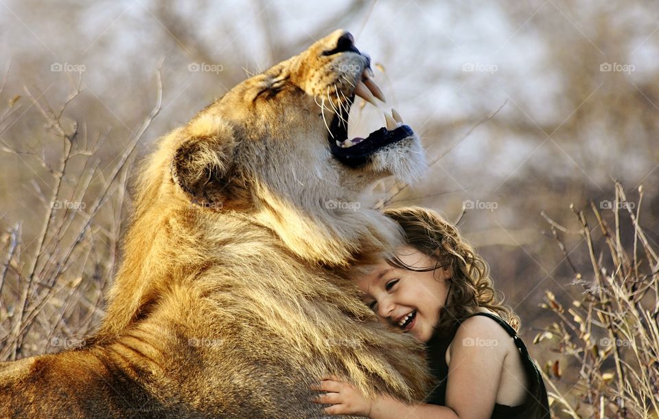 a little girl with her pet lion