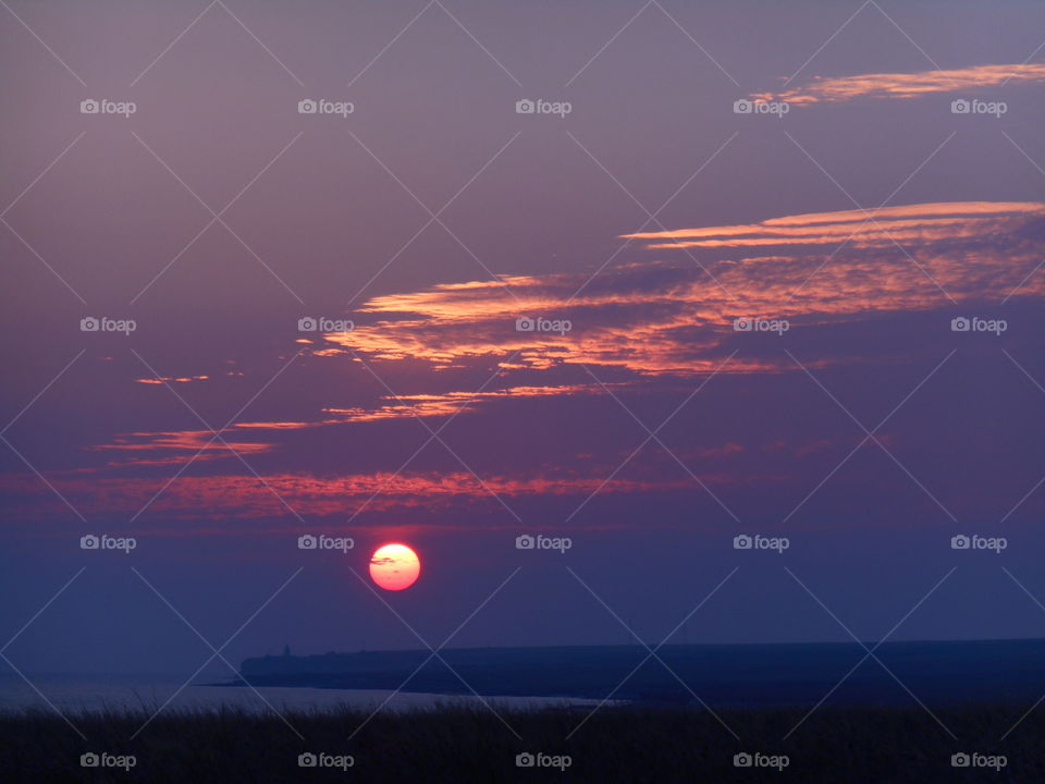 beautiful colorful sunset in the steppe and sea shore summer landscape