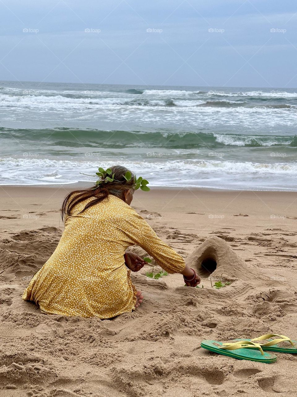 Woman building sand castles on a beach