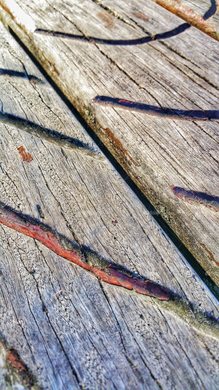 Contrasting texture and patterns on weathered wooden planks.