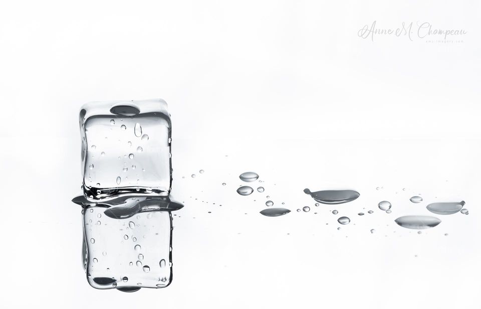 Melting ice on white with reflection