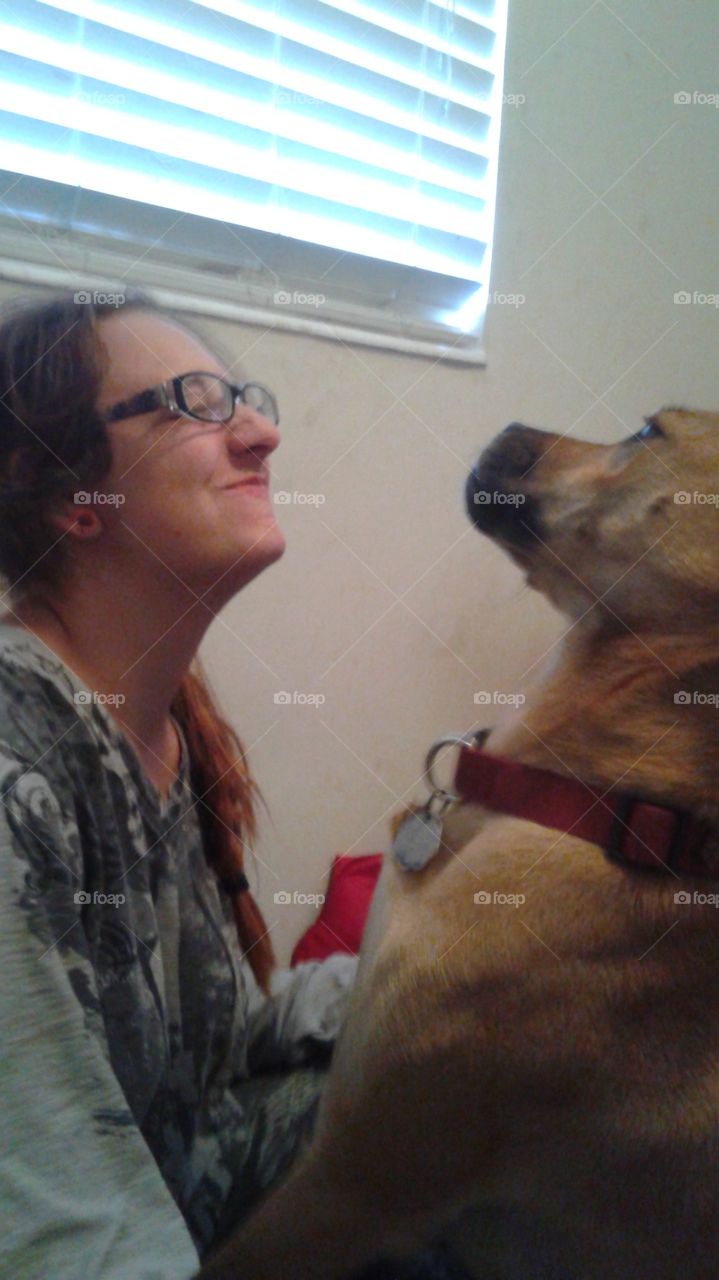 puppy love. my best friend playing with her dog. giving kisses.
