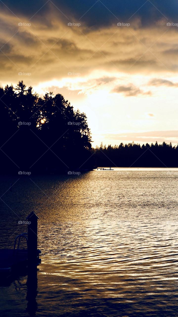 American Lake, Washington is quiet as the sun sets on a summer evening. Sepia tone 