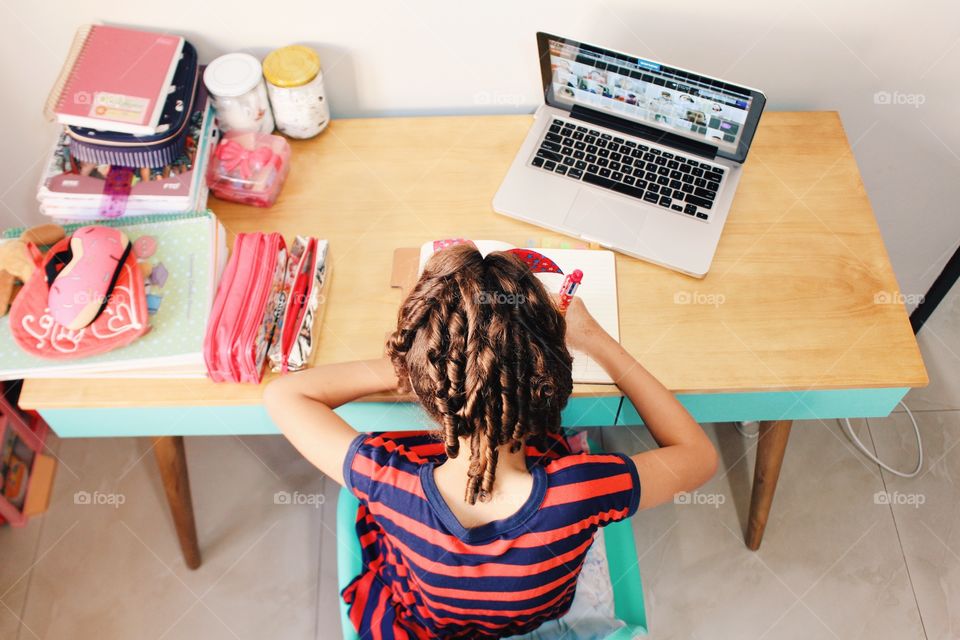 Little girl watching online classes in quarantine