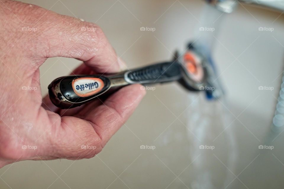 Razor blade being washed with water