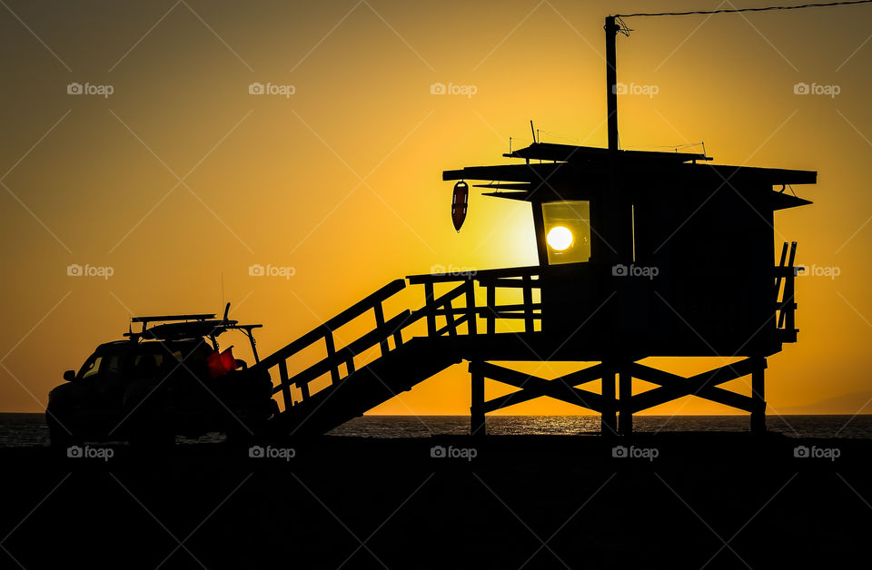 Sunset captured at Venice beach peeking through window of rescue tower