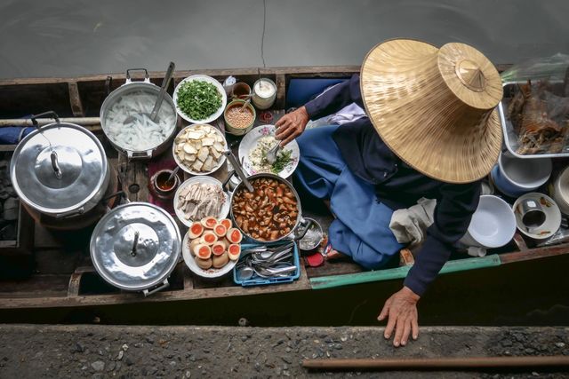 Time to eat Thai street food in floating market in Thailand
