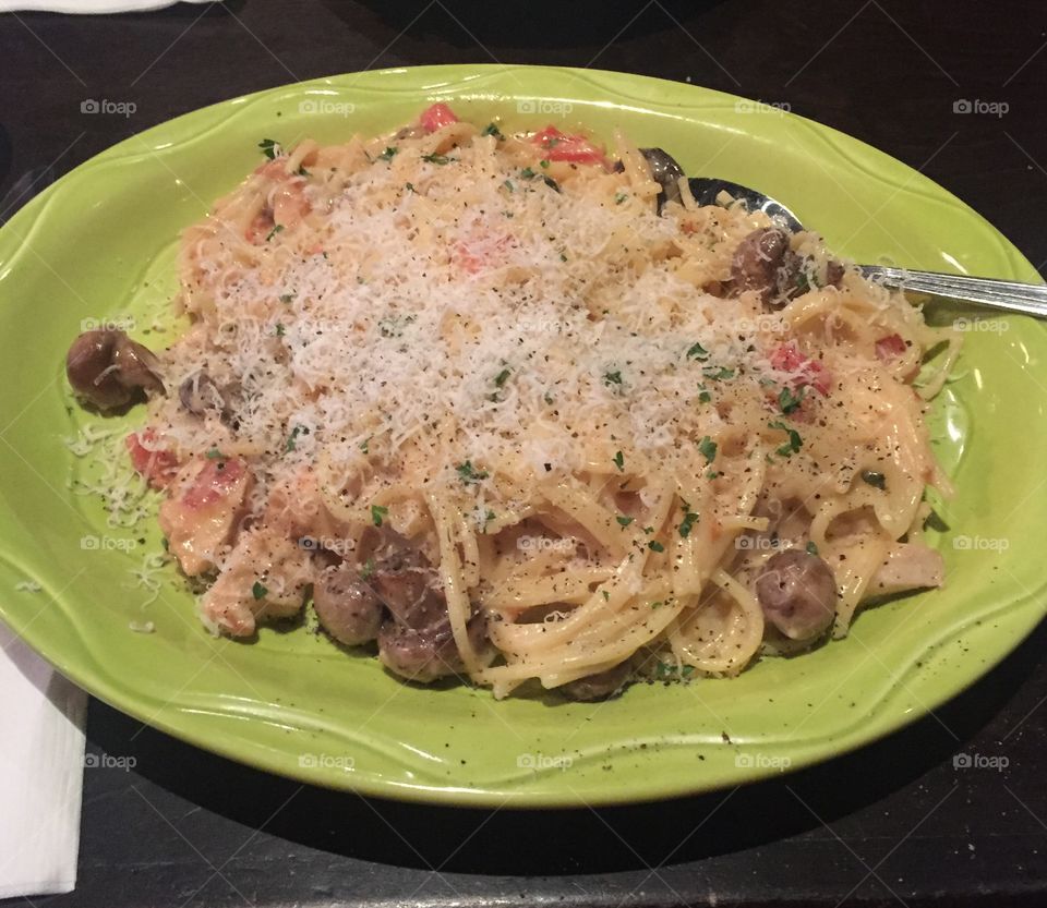 Delicious plateful of warm pasta with mushrooms and sprinkled with cheese. What a comforting dish