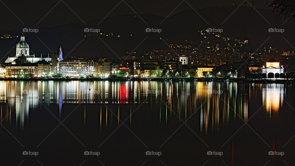 Palaces, lights and reflections of the Como lakefront, from the cathedral to the Volta temple, seen from the lake