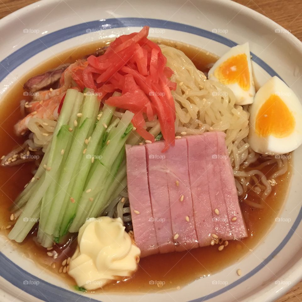 Cold ramen with shrimp, Japanese roast pork, ham, egg and cucumber in lemon sauce garnished with mayonnaise and pickled ginger great for any use.
