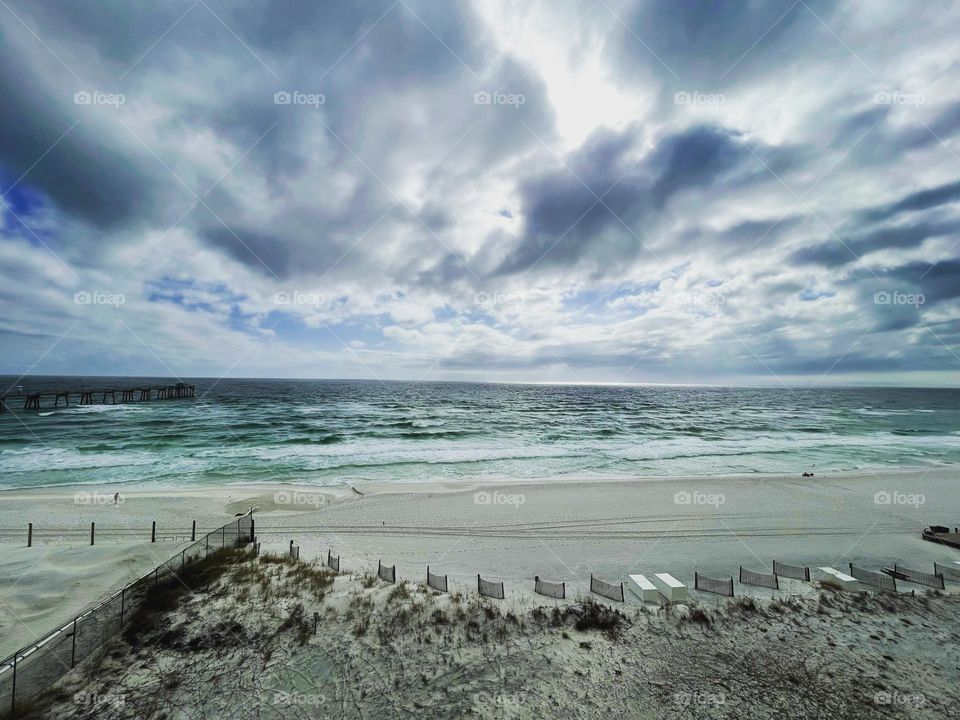 Rough surf on a beach with dramatic clouds