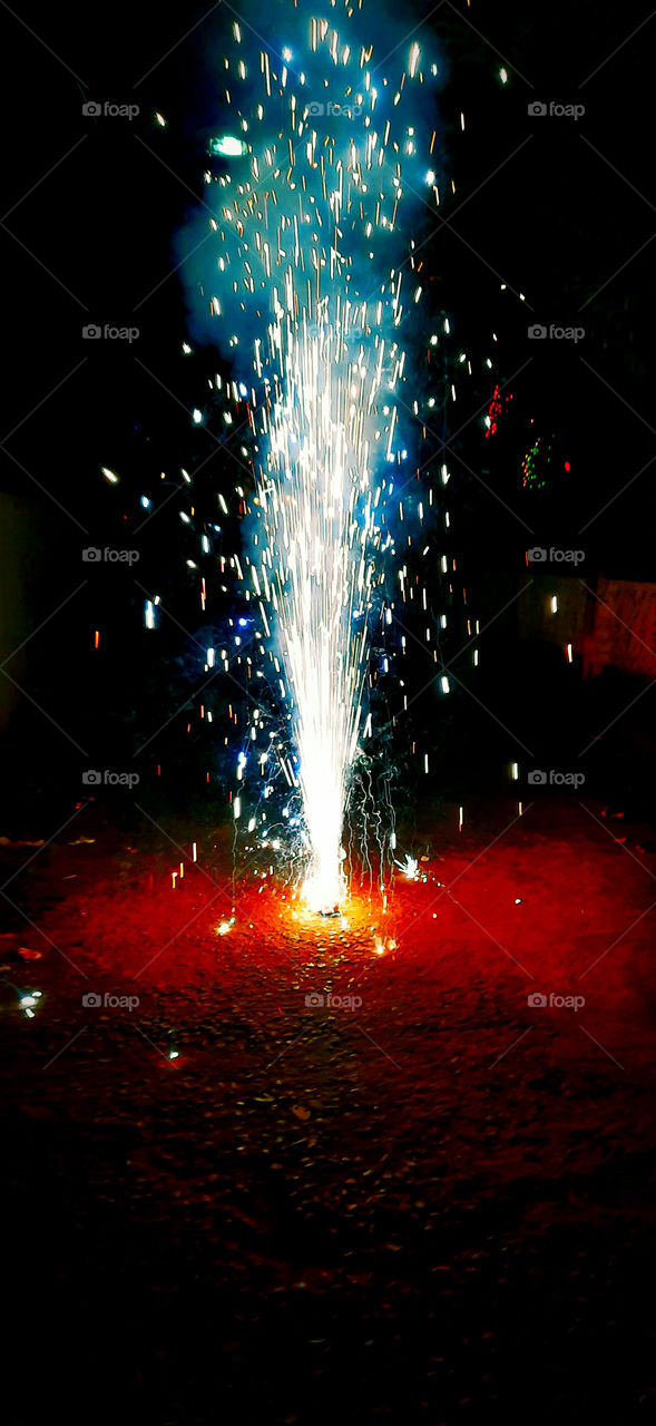 Ignited flower pot crackers firework for celebrating Diwali festival.A beautiful and colourfull image captured.