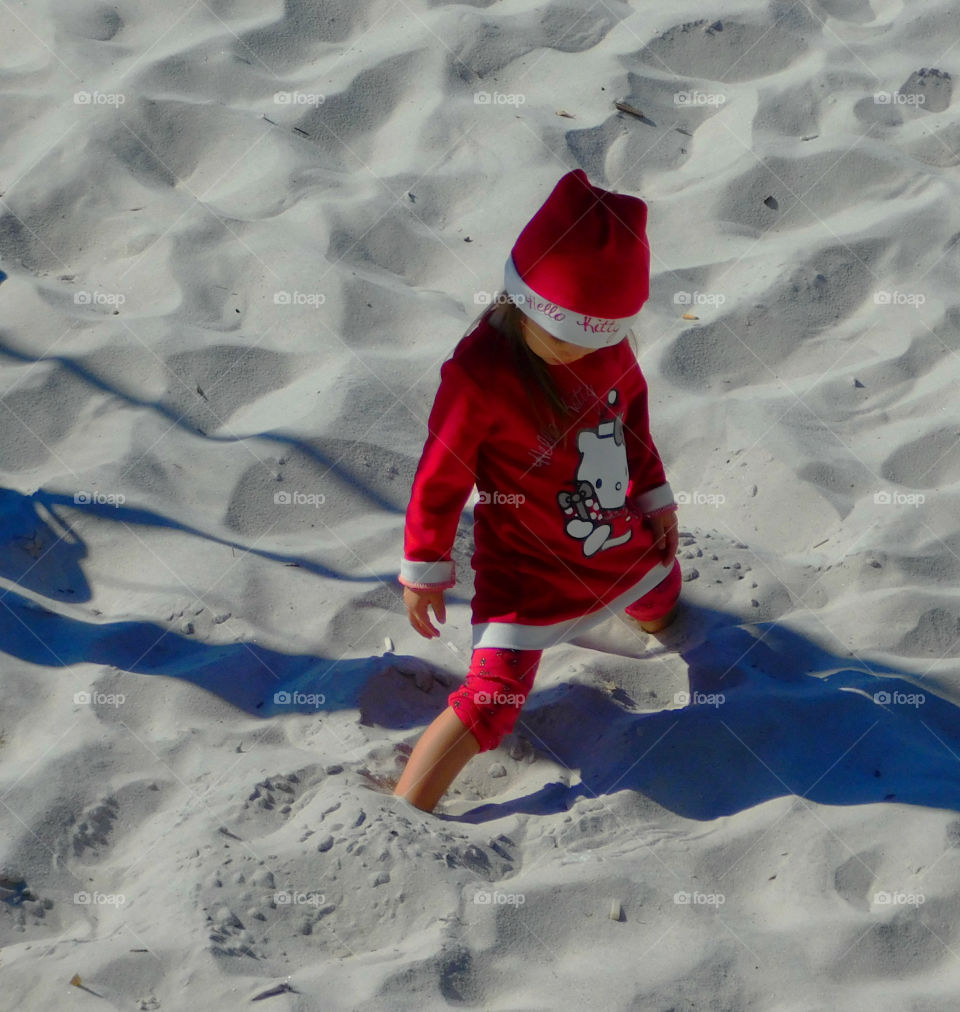 Dressed in her Hello Kitty outfit playing in the Florida snow (Sand)!