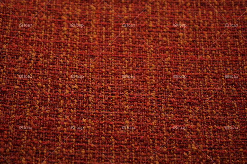 Orange and yellow small weave patterned pillow close-up