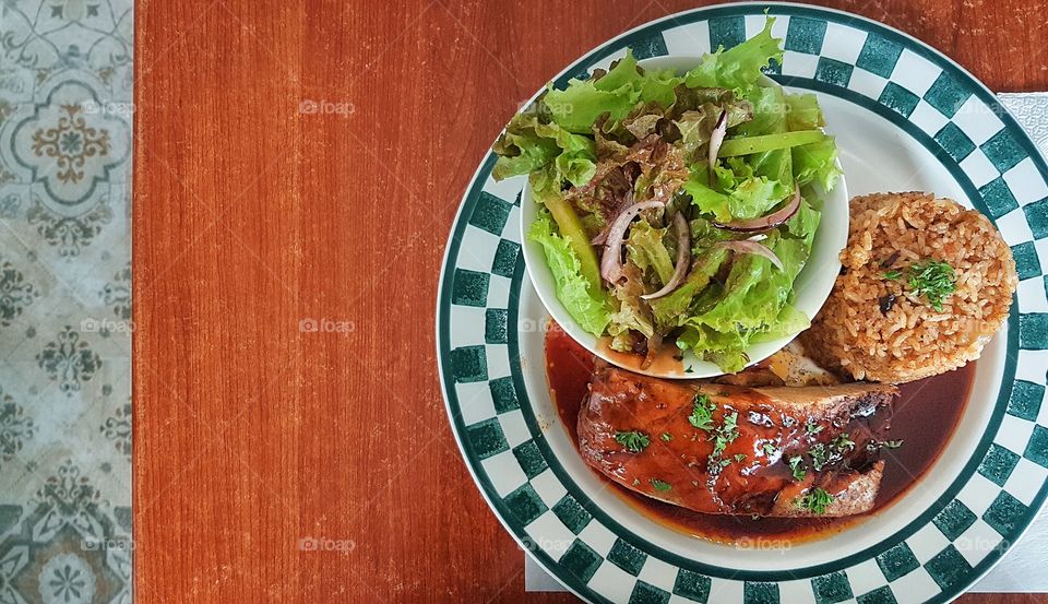 pork barbecue ribs with cajun rice and vegetable salad
