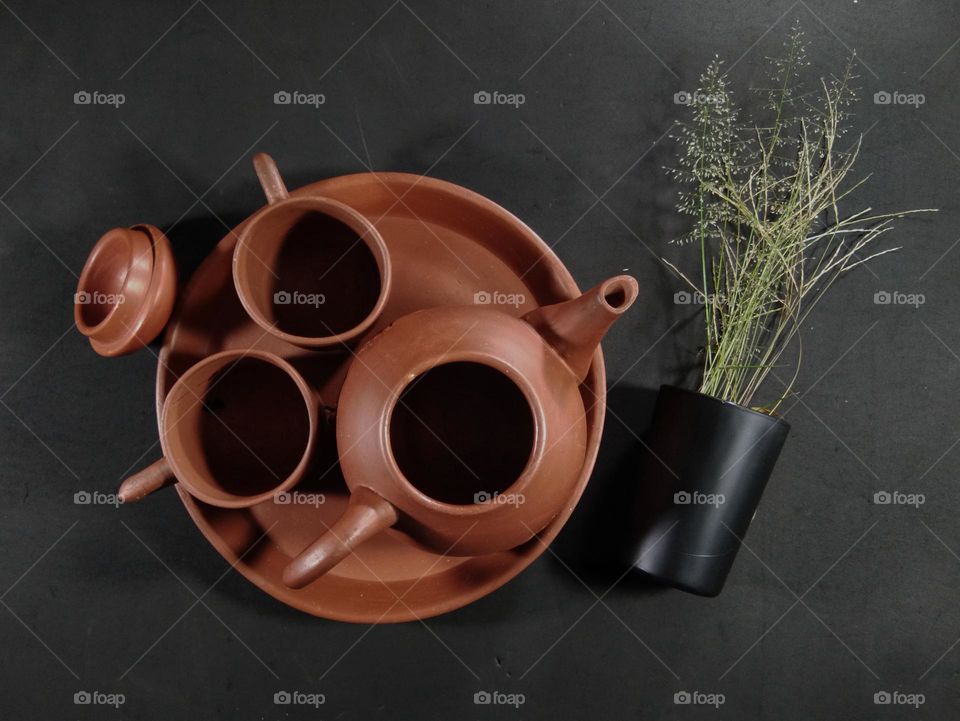 top view of tea pot on black background