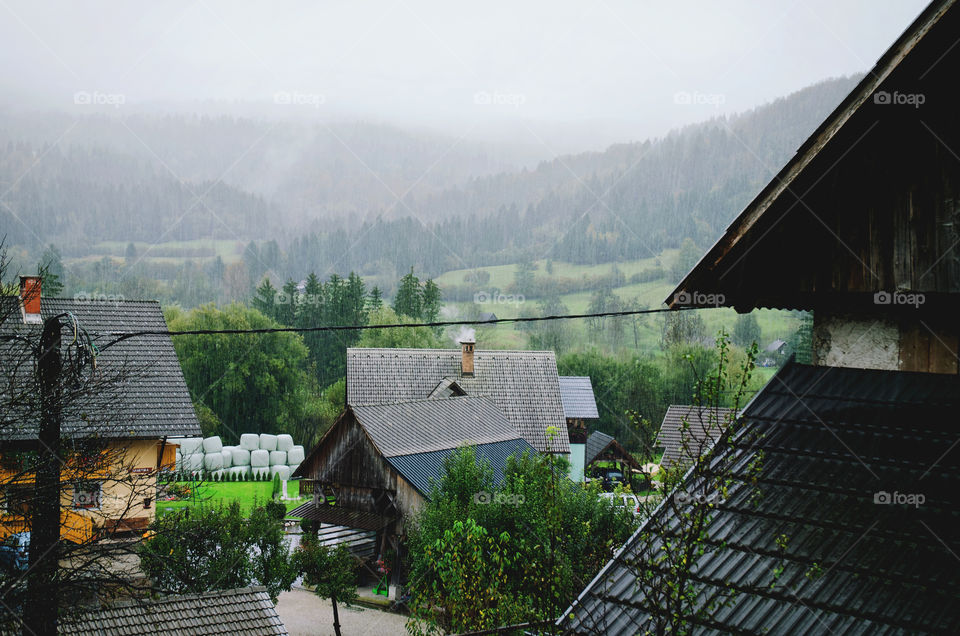Scenic view of the autumn mountains landscape against the village in Slovenian Alps.