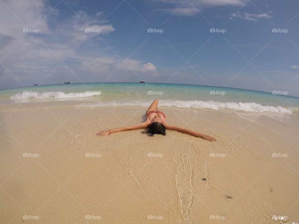 girl laying on the beach