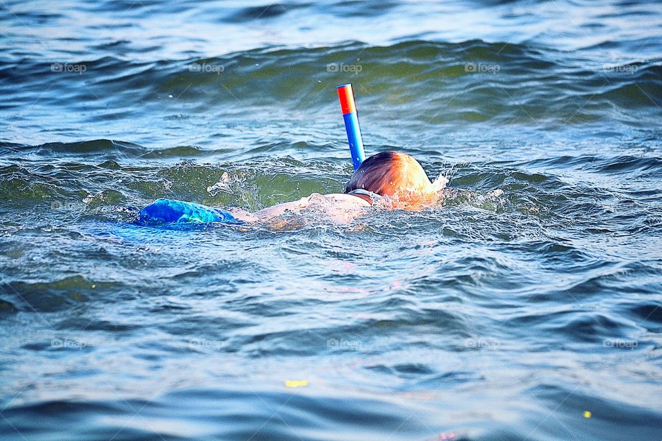 Swimming. A boy swimming in the ocean