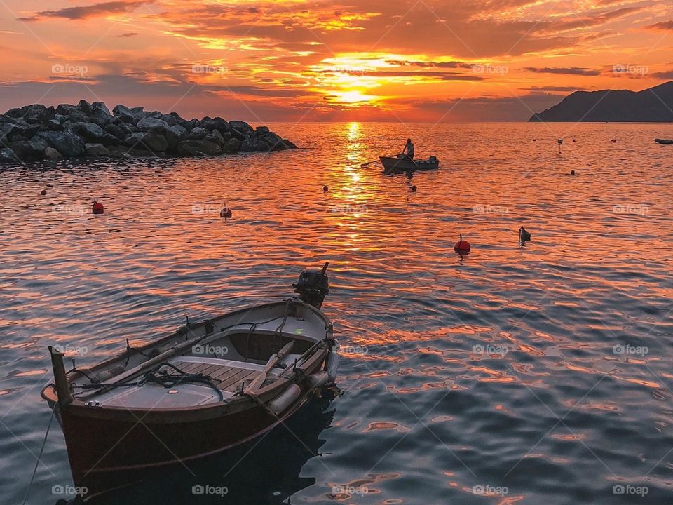A beautiful picture with boats on a river and a sunset
