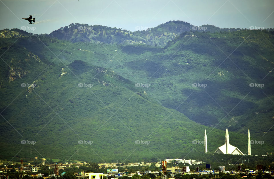 Islamabad on Defense Day. A PAF F-16 performing on Pakistan Defense Day in the Capital  with the beautiful Margallah hills in the background.