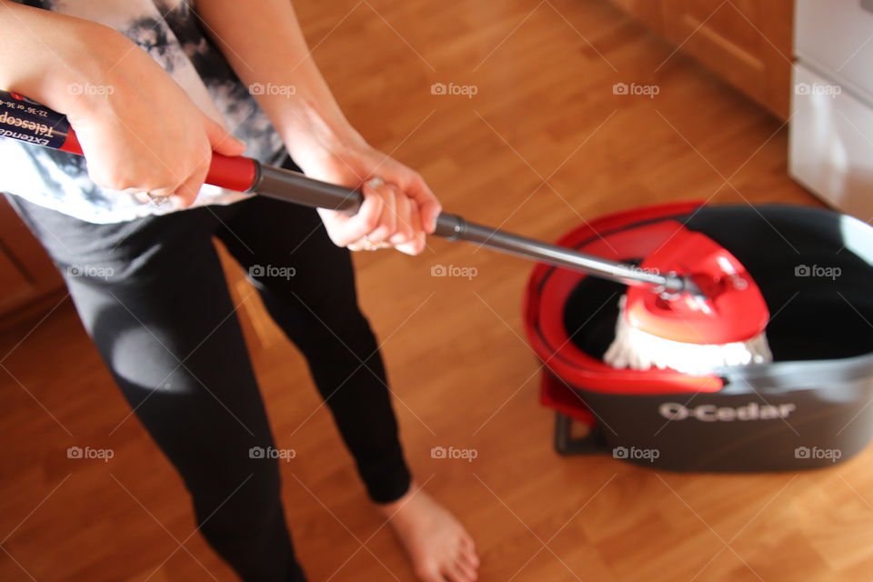 Girl using O-Cedar mop and bucket 