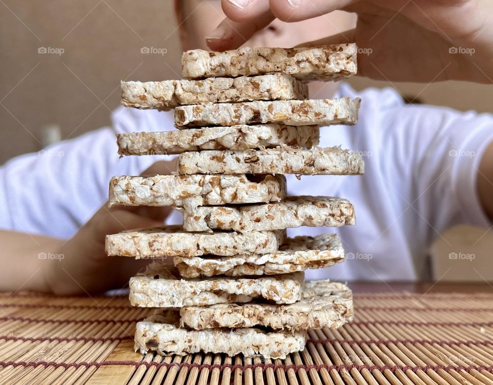 child folds a pyramid of square slides