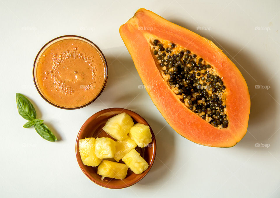 Papaya smoothie on white background