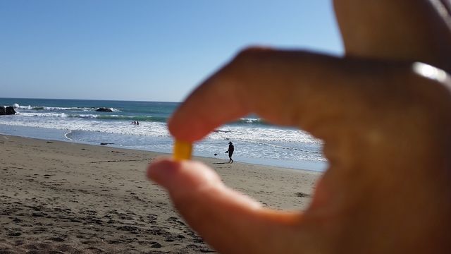 Photographer's prespective. Looking for the perfect pebbleb on a beach.