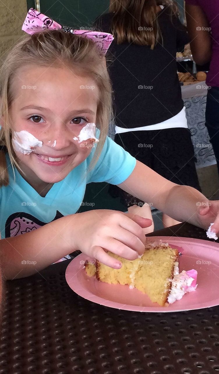 Cute girl child eating cake