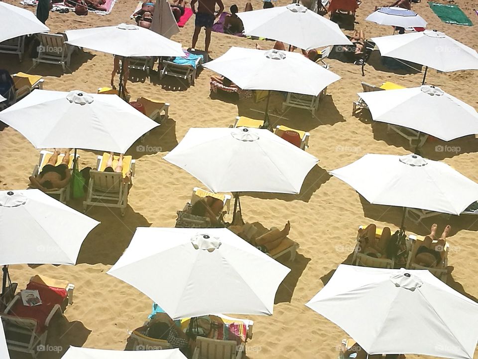 White umbrellas in a beach.