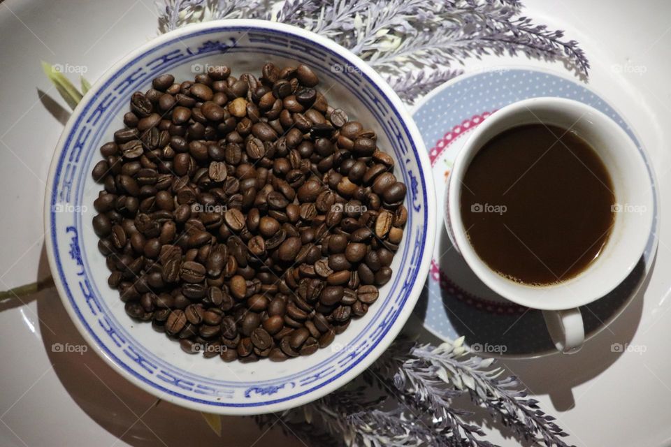 A cup of coffee and coffee beans