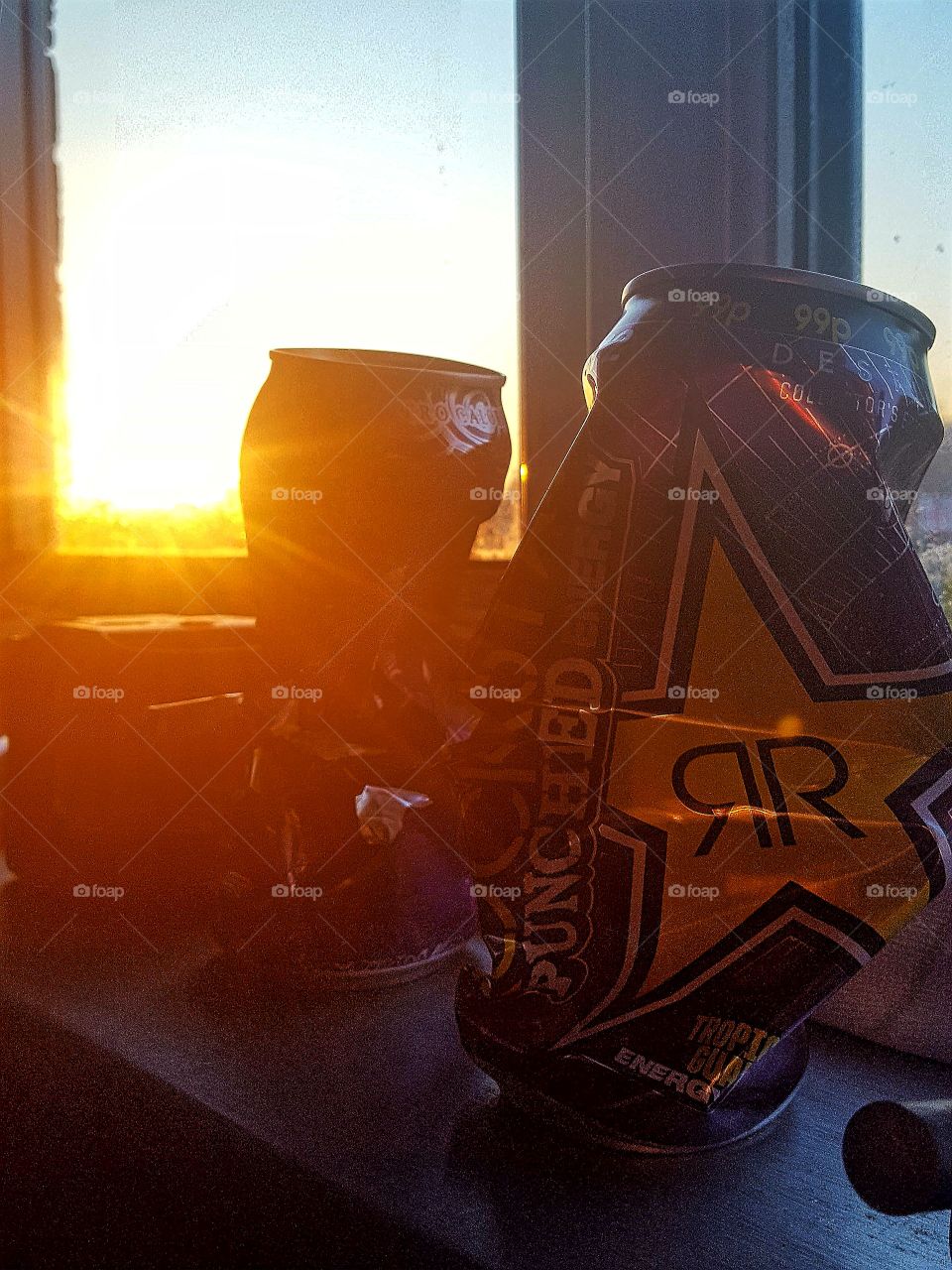 sunset with destroyed energy drink cans