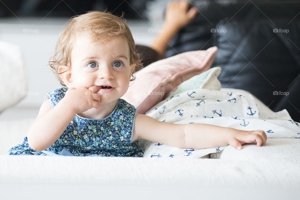 Cute baby girl with finger in mouth