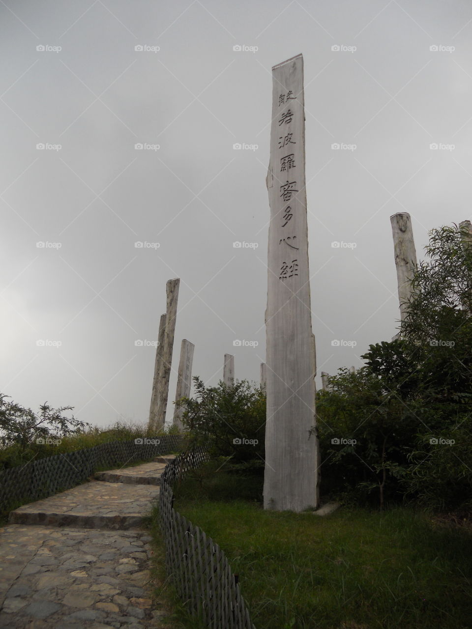 The Heart Sutra carved on wooden posts along a path surrounding the "Big Buddha" (Tian Tan Buddha)  on Lantau  Hong Kong