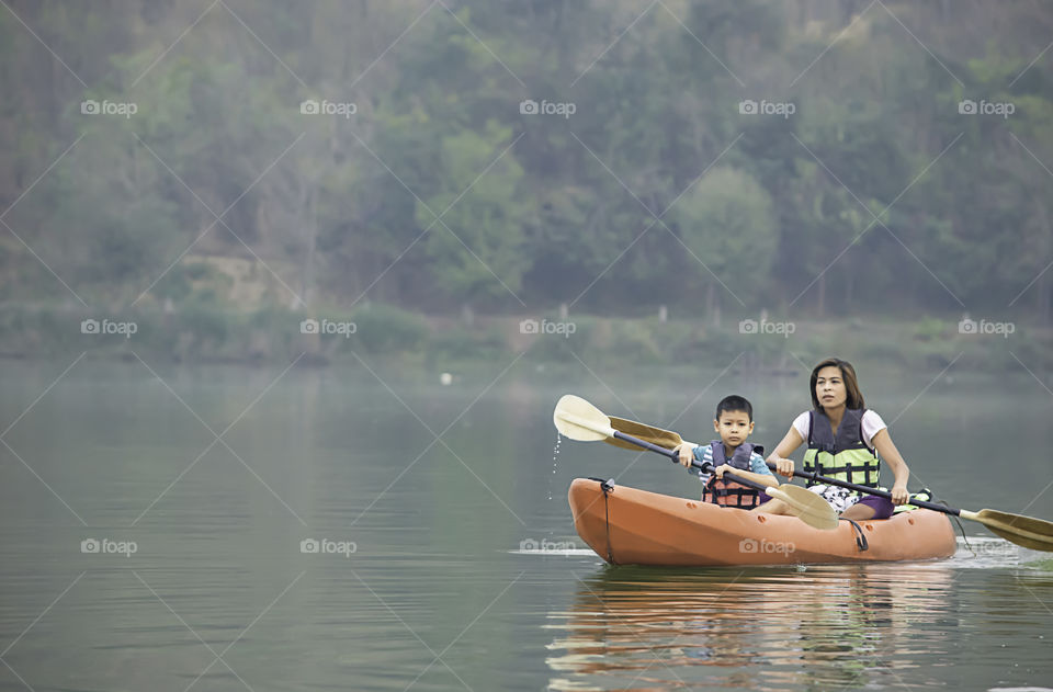 Mother and son kayaking in the reservoir.