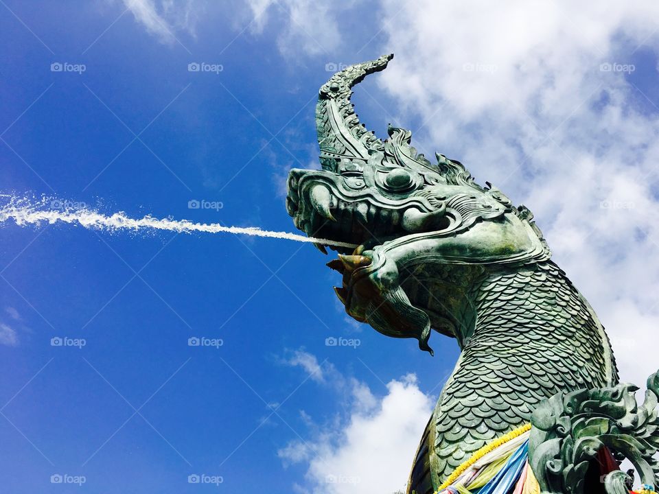 The great serpent or naga statue in thailand with blue sky