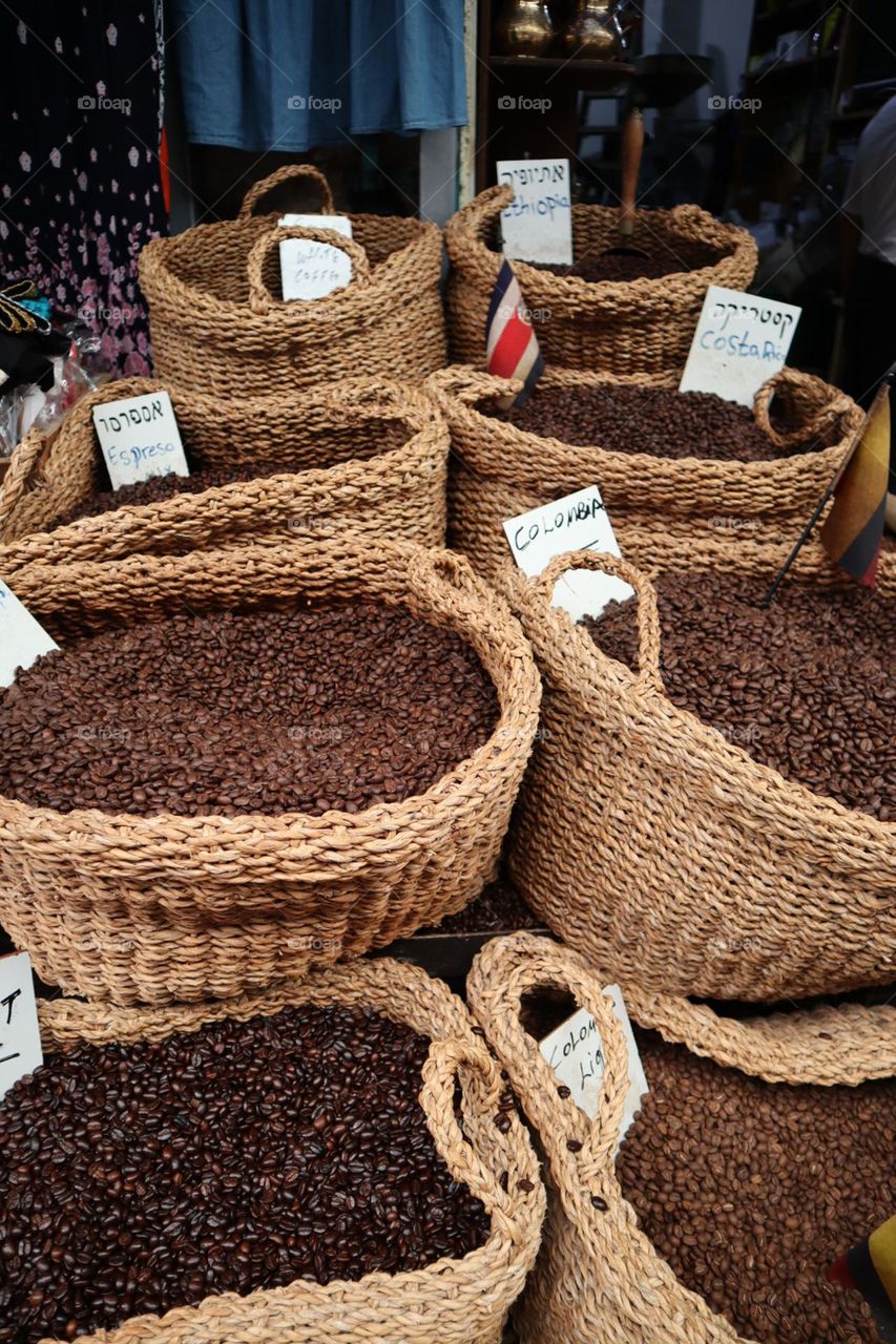 Different kind of coffee beans in baskets in market