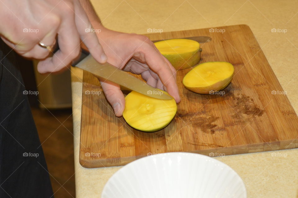 Women cutting fruit on cutting board