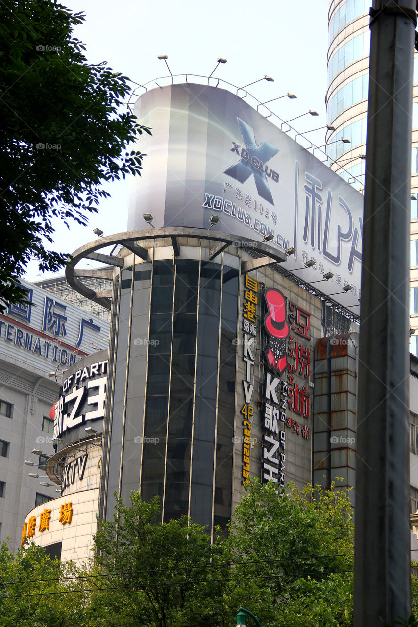 Commercialised building. A building in Shanghai, China with some fancy commercials on it.