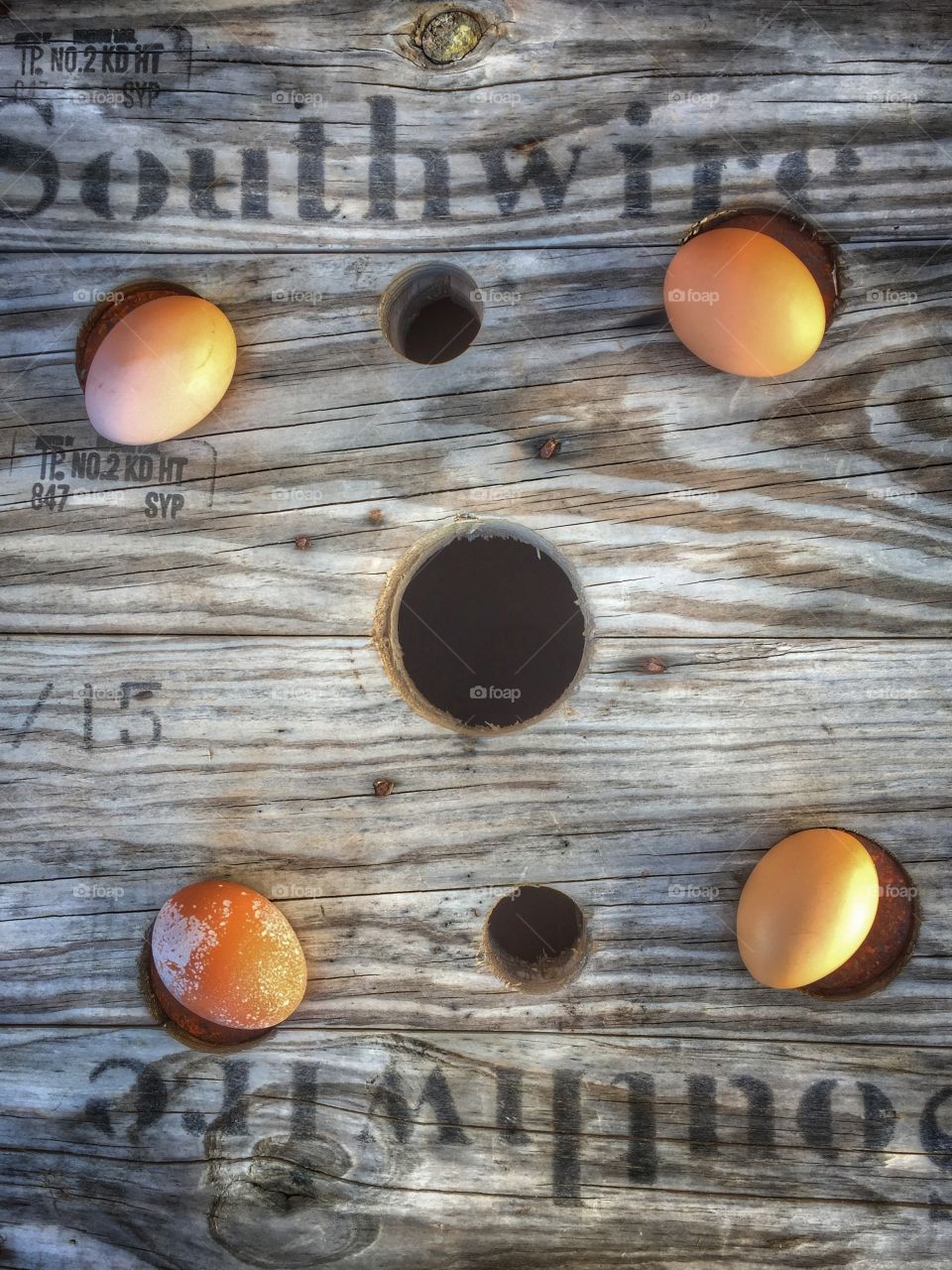 Four brown eggs on an old spool