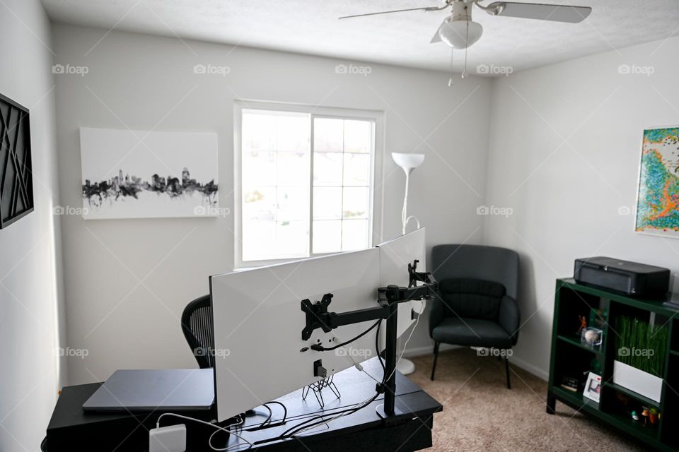 Home office desk with multiple computer monitors 