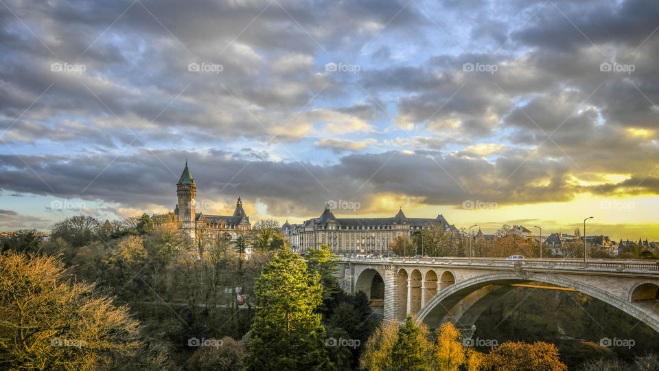 Sunset illuminates Supper Kess bank and Adolphe Bridge in Luxembourg.