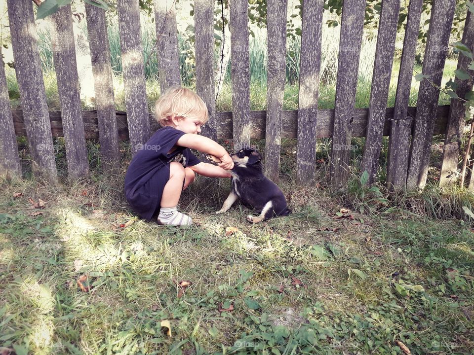 child and a funny puppy