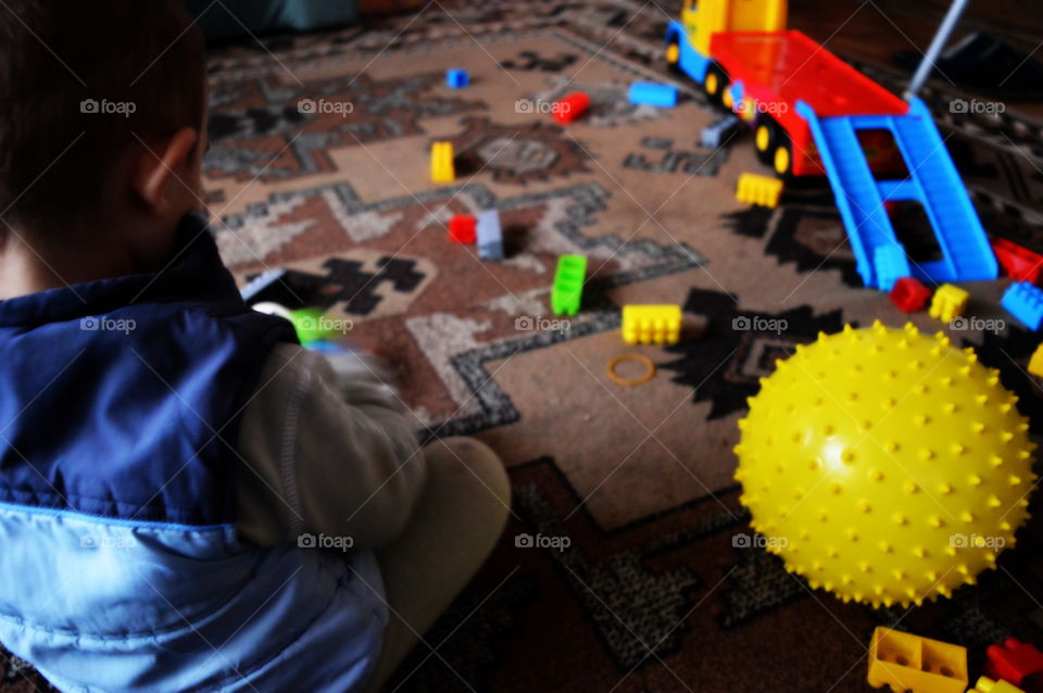 boy playing a yellow ball