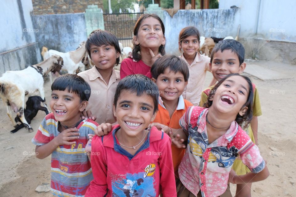 A company of smiling Indian kids at the village