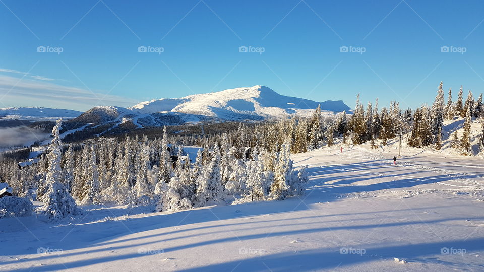 People skiing on mountain slope