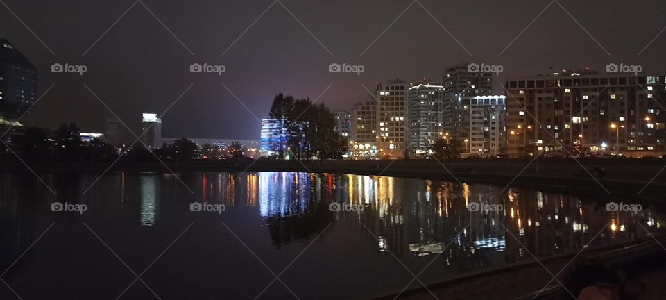 beautiful night light street view, windows magic light, cityscape and reflection in river