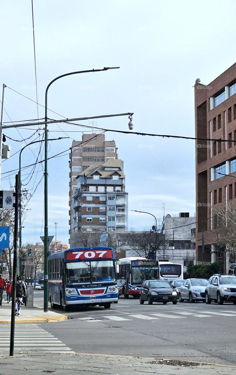 Bus route 707 and other buses, and cars at a stop light